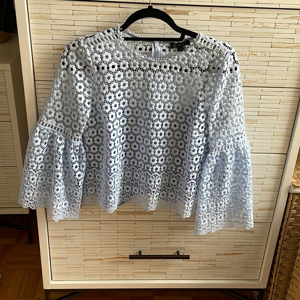 J. Crew eyelet light blue blouse with puff sleeves.